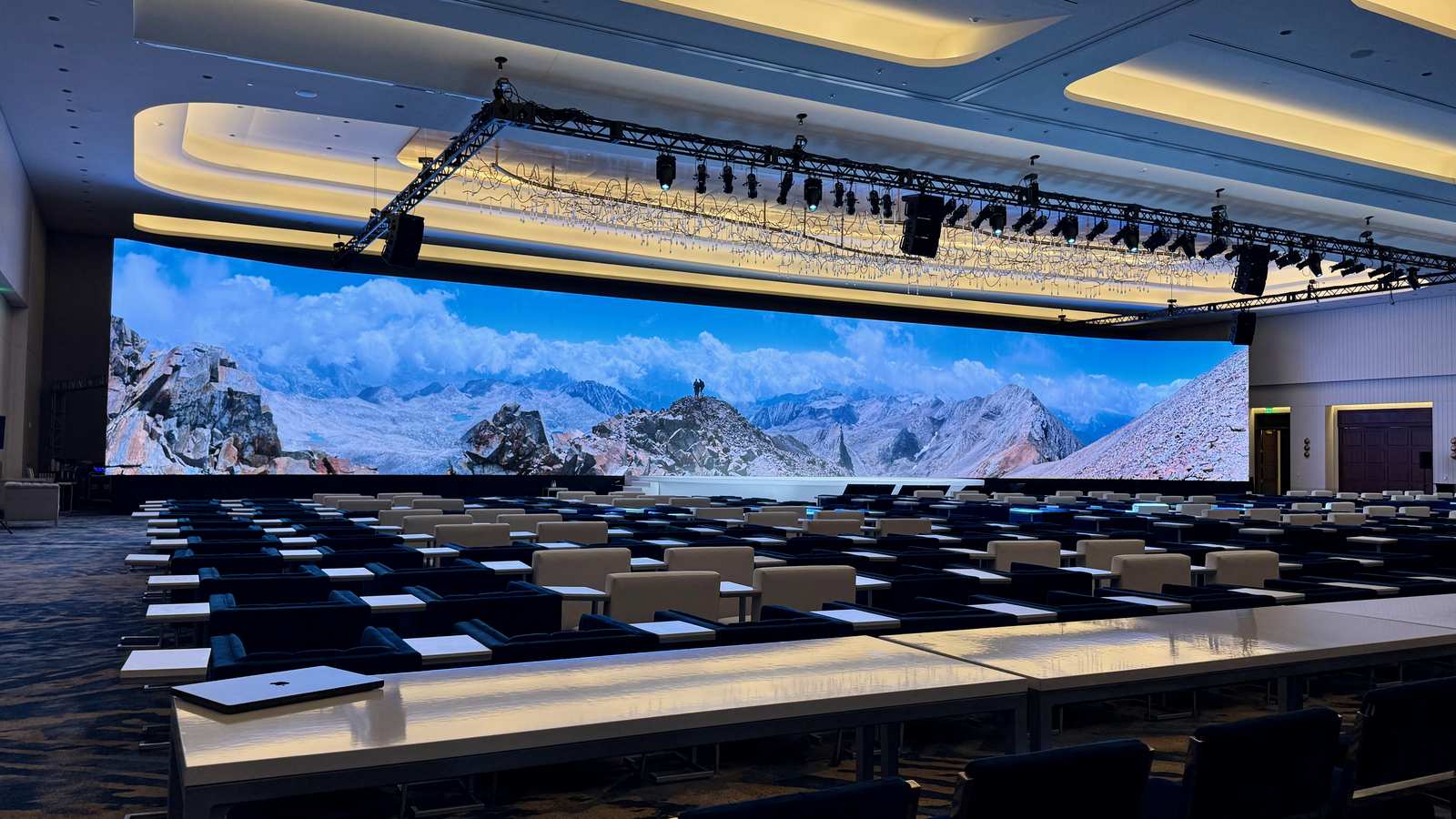 Mountain panorama on a full-width LED wall over classroom-style seating