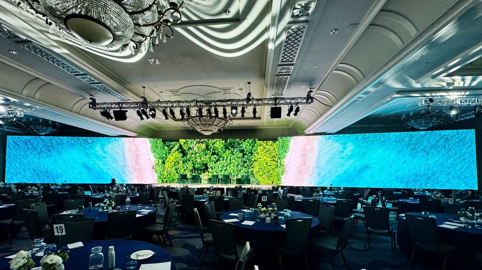 Ocean and forest imagery across LED walls in a hotel ballroom
